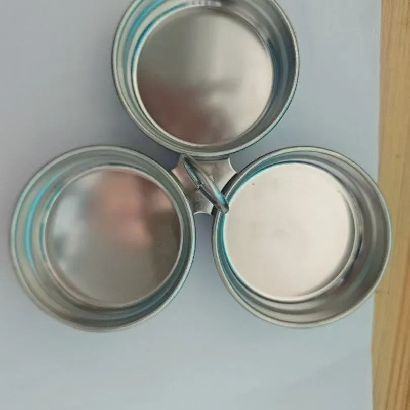 Mini stainless steel egg steamer for creating heart-shaped and round boiled eggs.