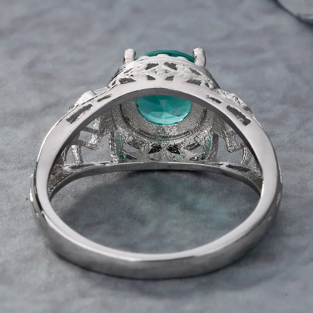 Copper electroplated silver ring with a clear zircon stone inlay on a neutral background