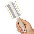 White double-sided dog and cat grooming brush with comb and deshedding head on a comfort-grip handle