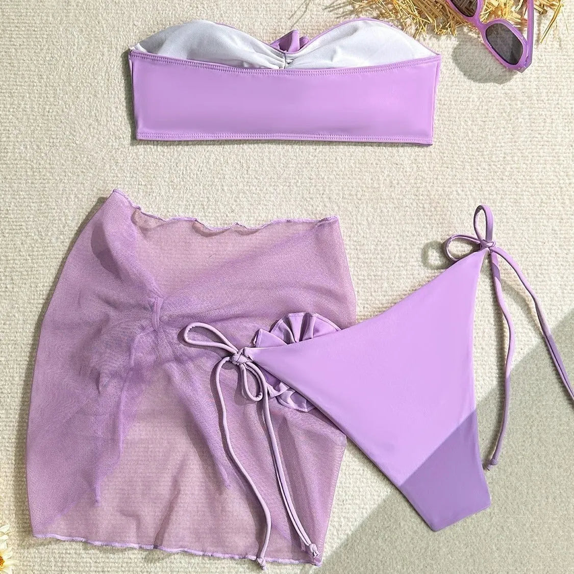 Pink women's tube top swimsuit with a large 3D flower and detachable skirt on a mannequin