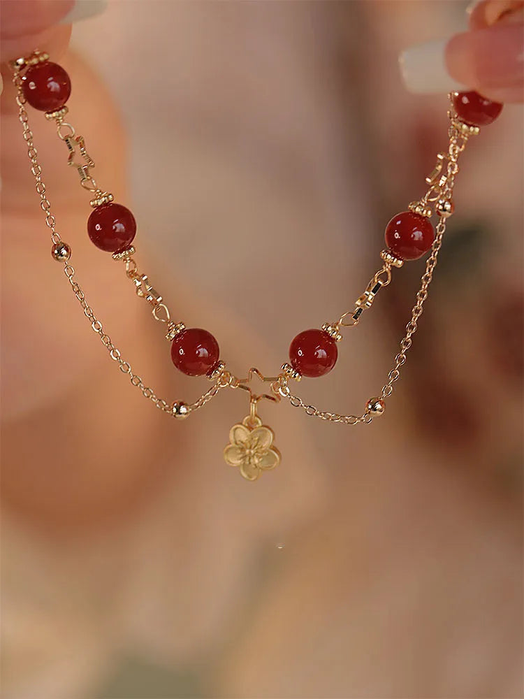 Women's red agate bracelet with double layer design and floral charms