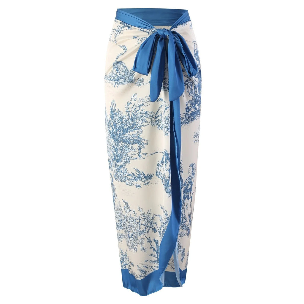 Blue women's one-piece polyester swimsuit with a matching gauze skirt laid flat.