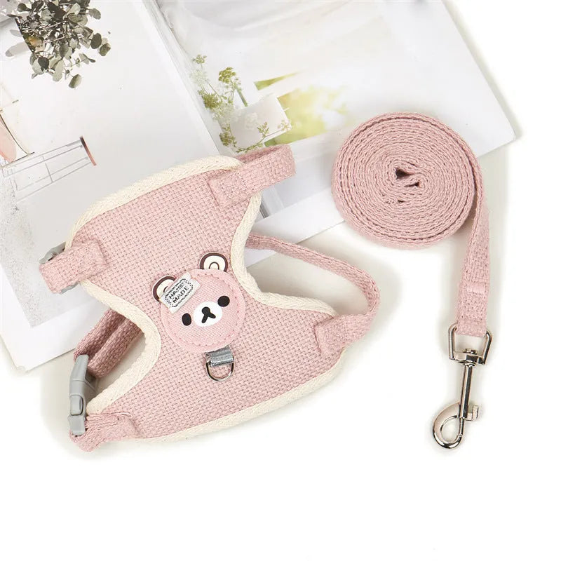 Adjustable dog hand holding rope vest with cloth chest strap and traction rope in beige on a flat surface