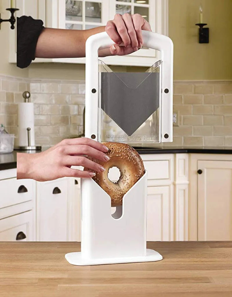 White plastic bagel guillotine slicer with clear acrylic safety shields and stainless steel serrated blade