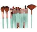 18-piece make-up brush set with fan-shaped brushes laid out on a table.