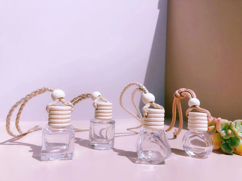 Glass car perfume pendant fragrance diffuser in cylinder, diamond, flat drum, and square styles.