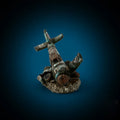 Resin simulated aircraft wreckage aquarium ornament 8cm by 4.5cm by 4.5cm on dark substrate