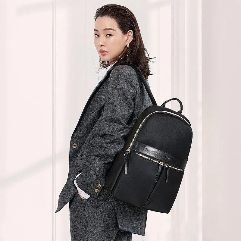 Women's black nylon backpack with zipper opening, internal computer sleeve, and phone pocket