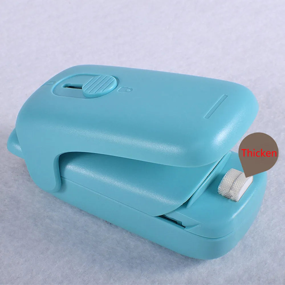 Mini hand pressure heat sealing machine in blue on white background, 10cm long ABS and metal body