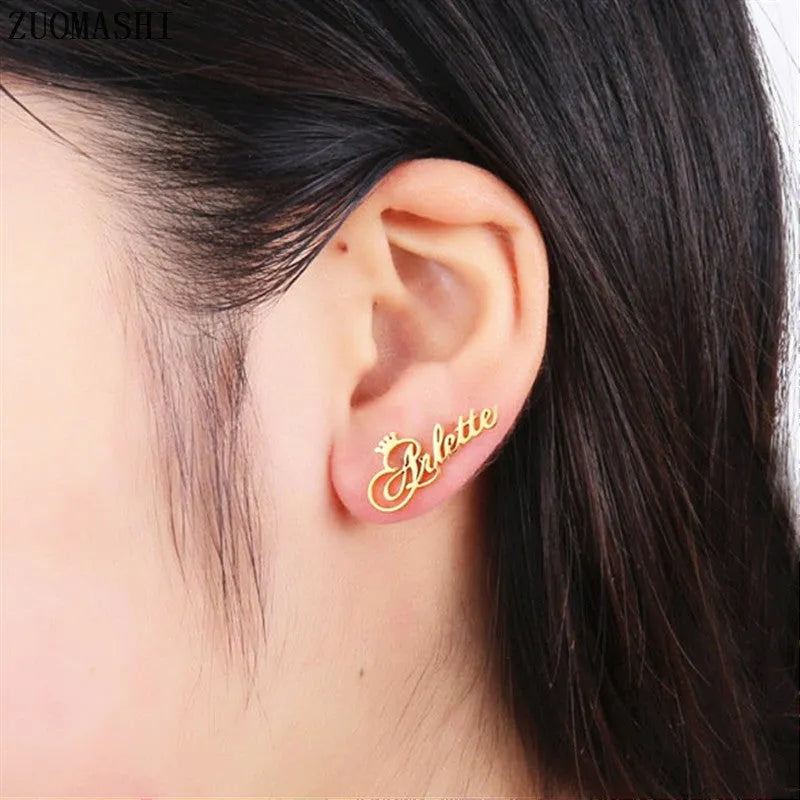 Custom English letter name earrings in rose golden finish on a plain background