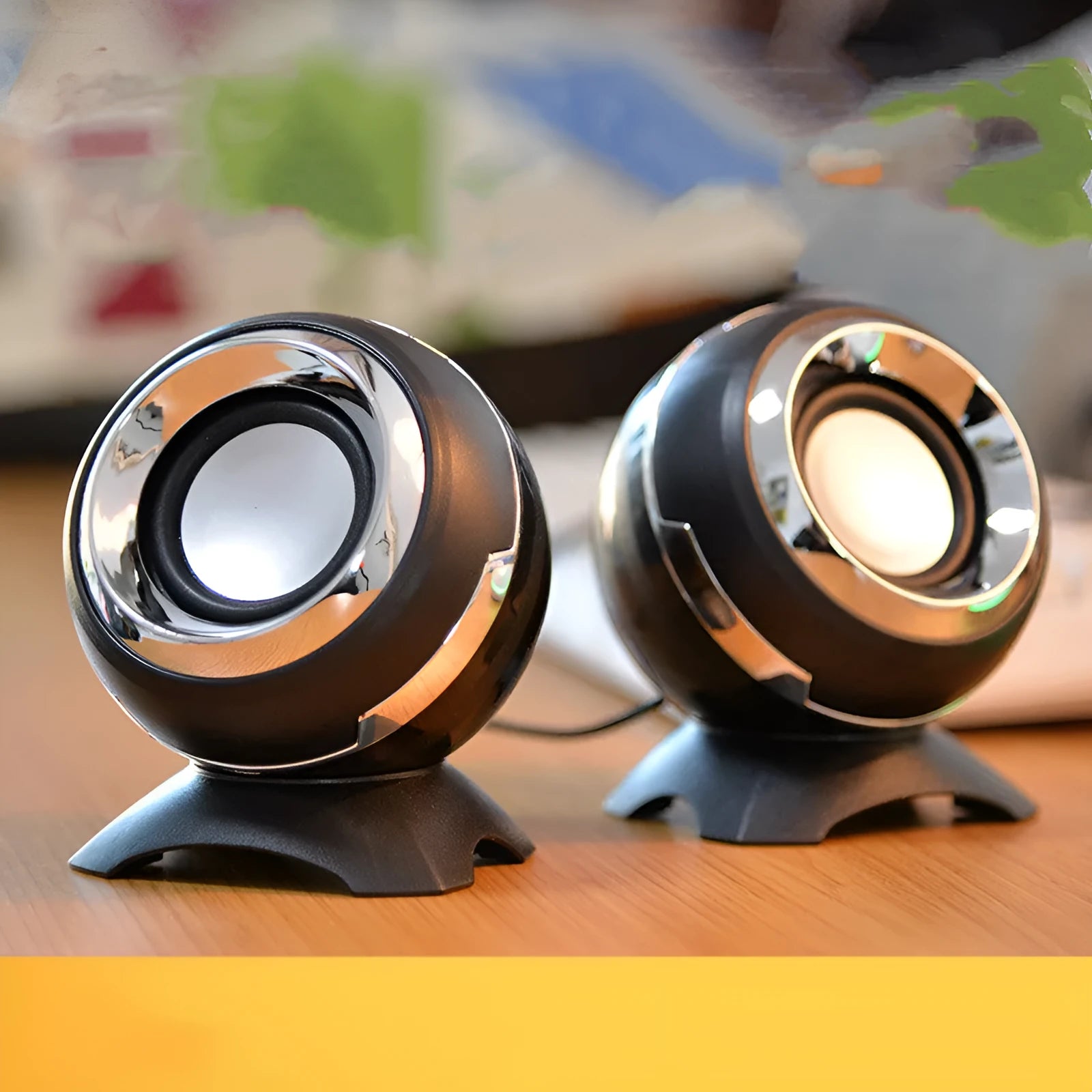 Black and gold USB-powered desktop computer speakers beside laptop showing compact 10cm dimensions