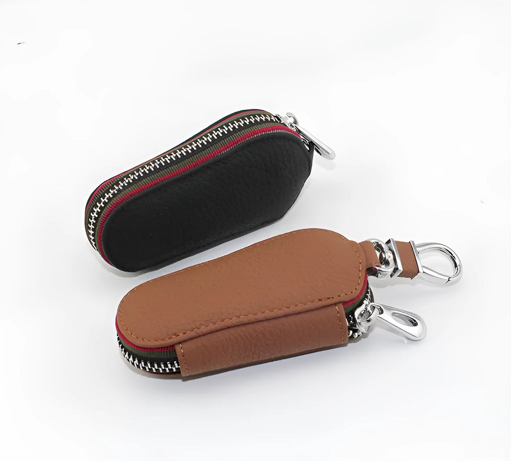 Brown leather car universal key case holding a car key on a white background