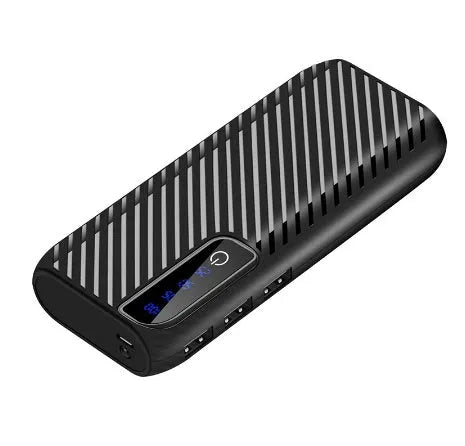 Black portable mini power bank with 20000mAh capacity showing USB ports, placed next to a mobile phone.