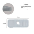 Silicone faucet splash guard mat in a choice of colours, showing sloped design with drain channels, placed around a sink faucet base.
