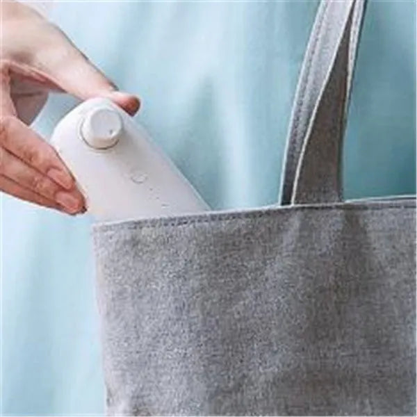 Mini hand pressure heat sealing machine in blue on white background, 10cm long ABS and metal body