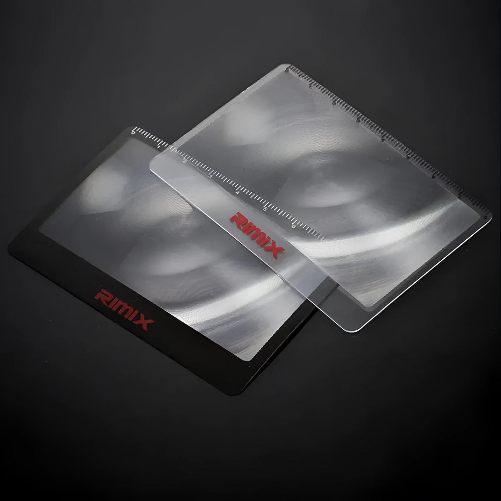 Portable black and white plastic card magnifier for close-up reading.