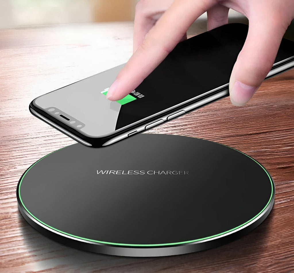 Black ultra-thin square wireless charging pad with USB cable on a desk.