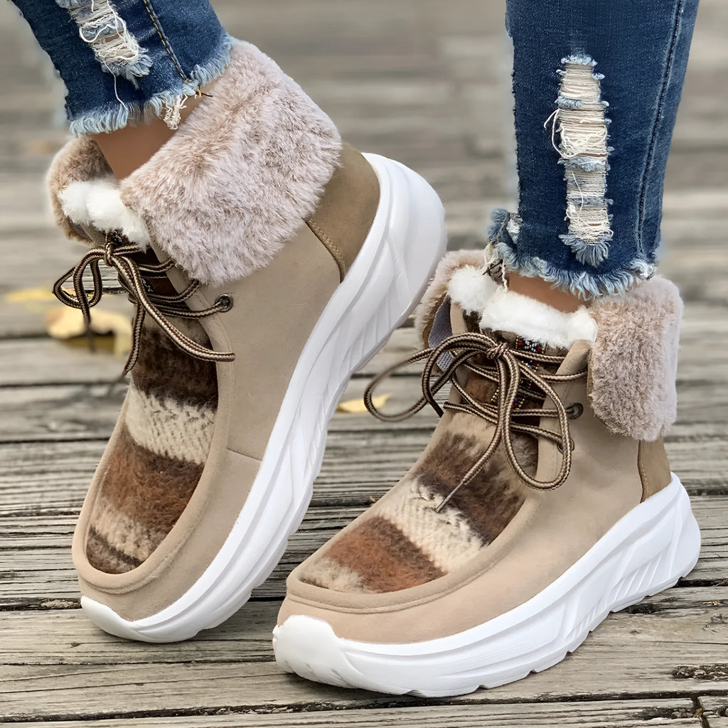 Beige women's lace-up suede snow boots with a thick platform sole and fur lining.