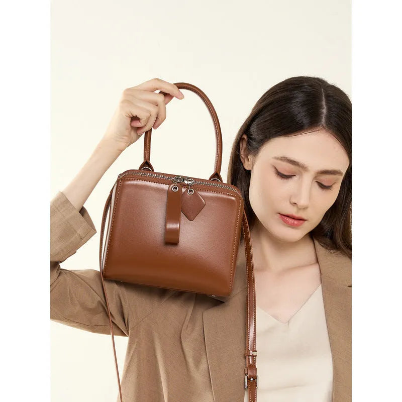 Open grain leather handbag with cowhide lining and welt pocket in black, brown or creamy white