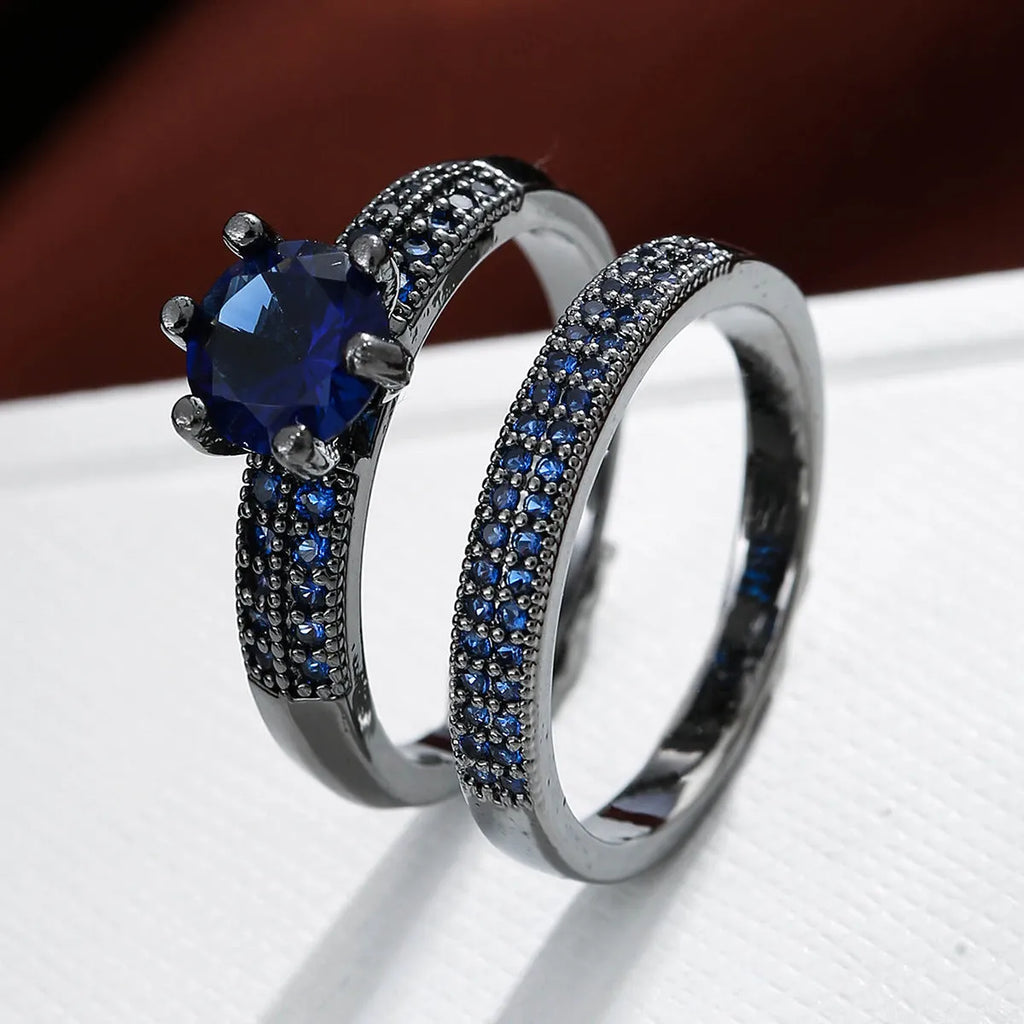 Geometric hollow copper ring with zircon electroplated finish in silver blue colour on a hand.