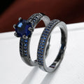 Geometric hollow copper ring with zircon electroplated finish in silver blue colour on a hand.