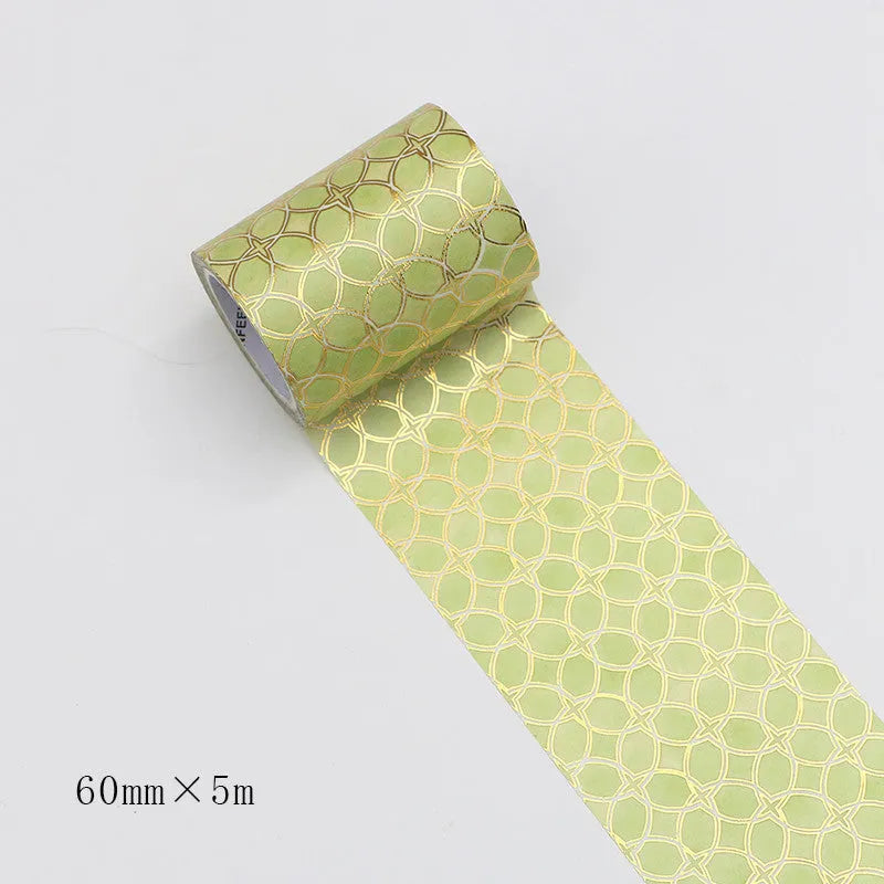 Roll of bronzing and paper decorative tape in gold colour, showing metallic finish.