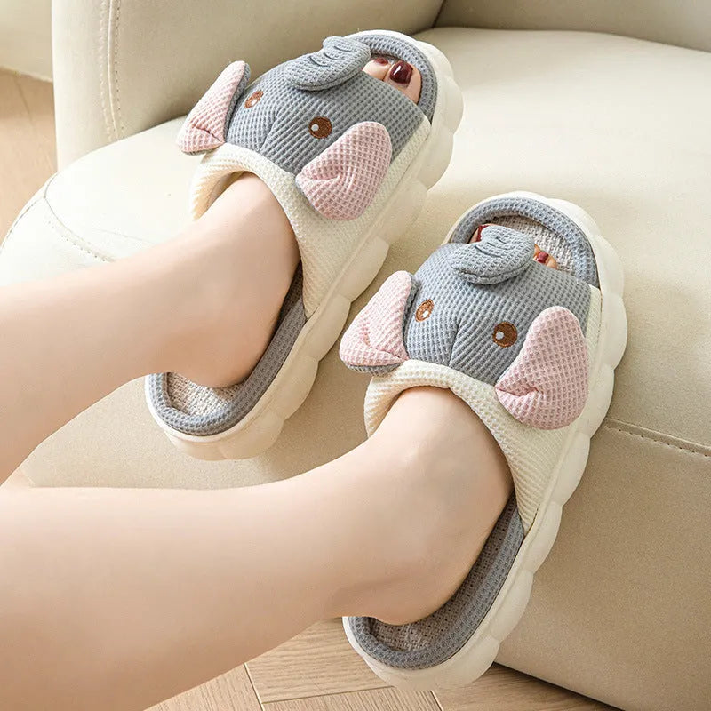 Elephant grey open-toe linen slippers for couples on a plain background, showing animal pattern detail and sewn sole.