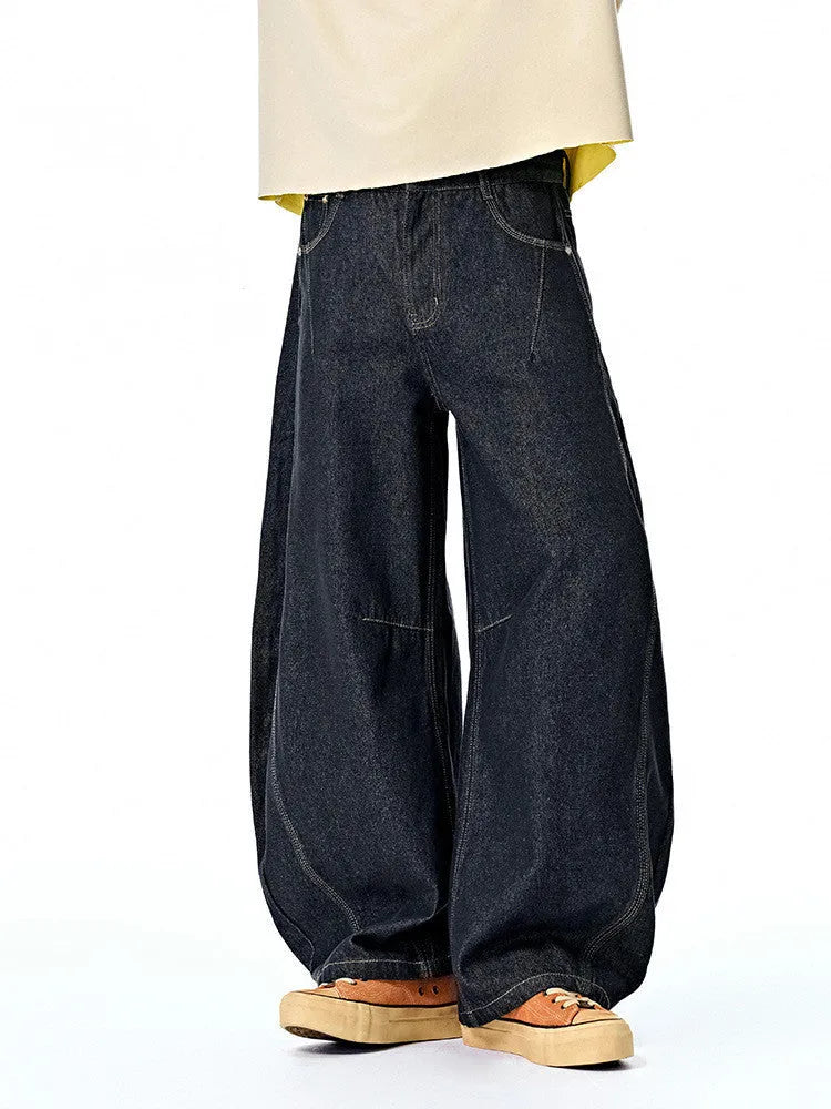 Men's wide leg denim trousers in original cow colour showing relaxed fit and mid waist design.