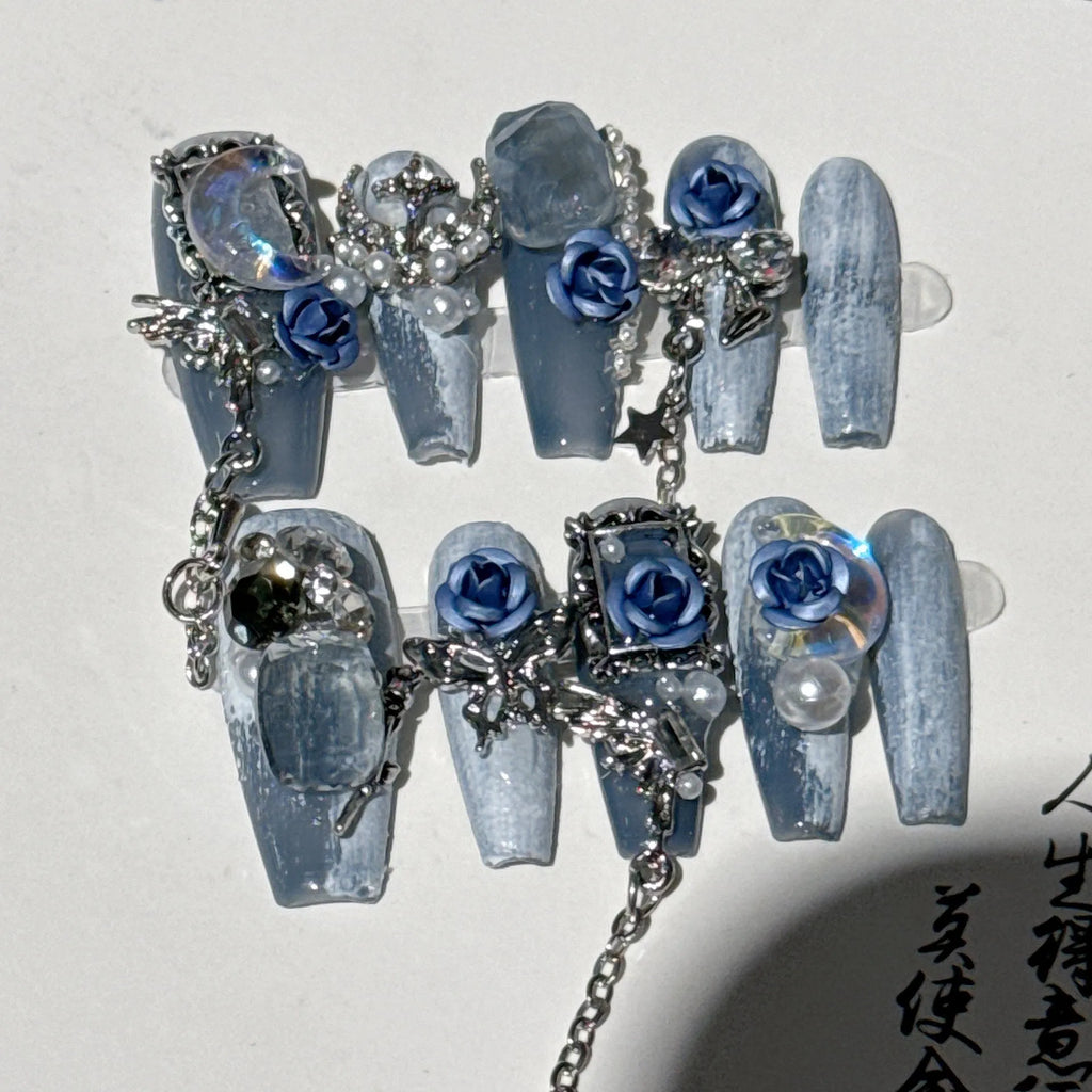 Heavy industry blue night manicure set with rose and tulip floral designs on plastic armour suit.