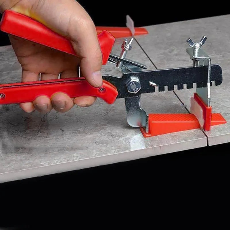 Red PVC and stainless steel tile leveling clip measuring 23 by 11.5 cm for floor tile installation