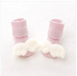 Cotton baby floor socks in various colours and patterns including pink bows, grey stars, and panda design.