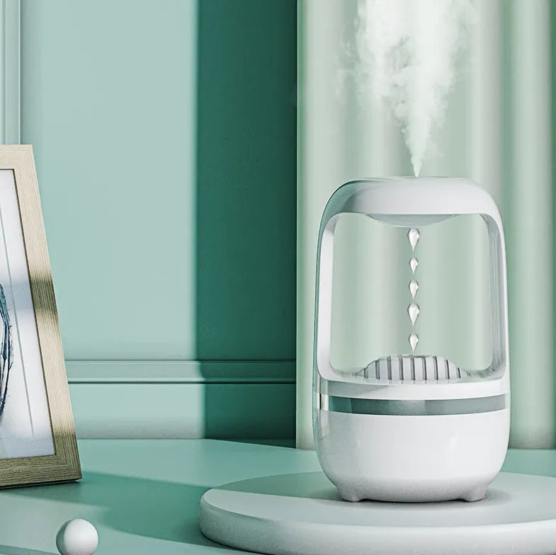 White anti-gravity humidifier showing water droplets flowing upwards, with USB cable and 500ml water tank.