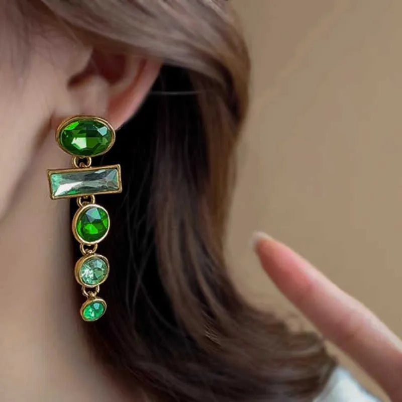 A pair of green gradient geometric alloy stud earrings with inlaid zircon stones and a dangling tassel.