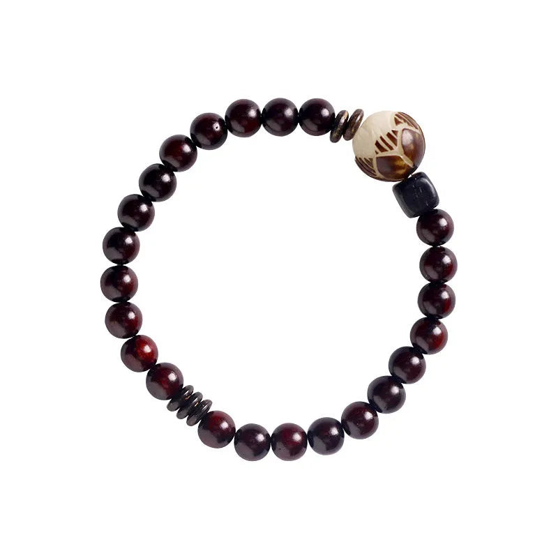 Rosewood bracelet with knitted construction showing floral carving details and 10mm diameter
