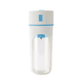Blue portable electric juicer with USB charging cable next to a cup of blended fruit smoothie.
