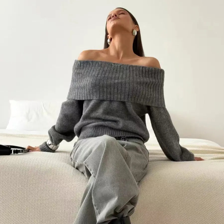 Woman wearing a grey off-the-shoulder sweater with a raised 3D texture pattern.