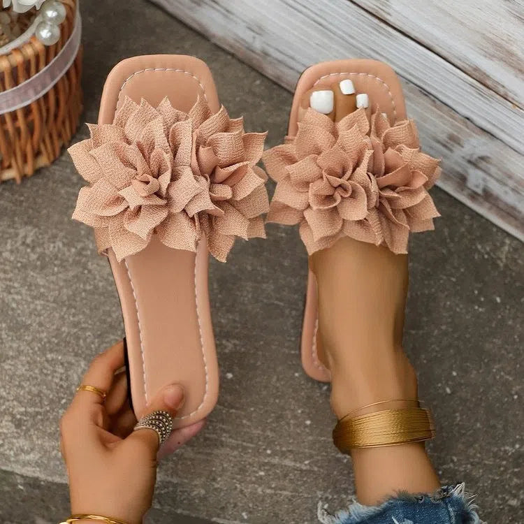 Women's flat flip-flops with flower detail, PU upper, rubber sole, apricot colour, on plain background