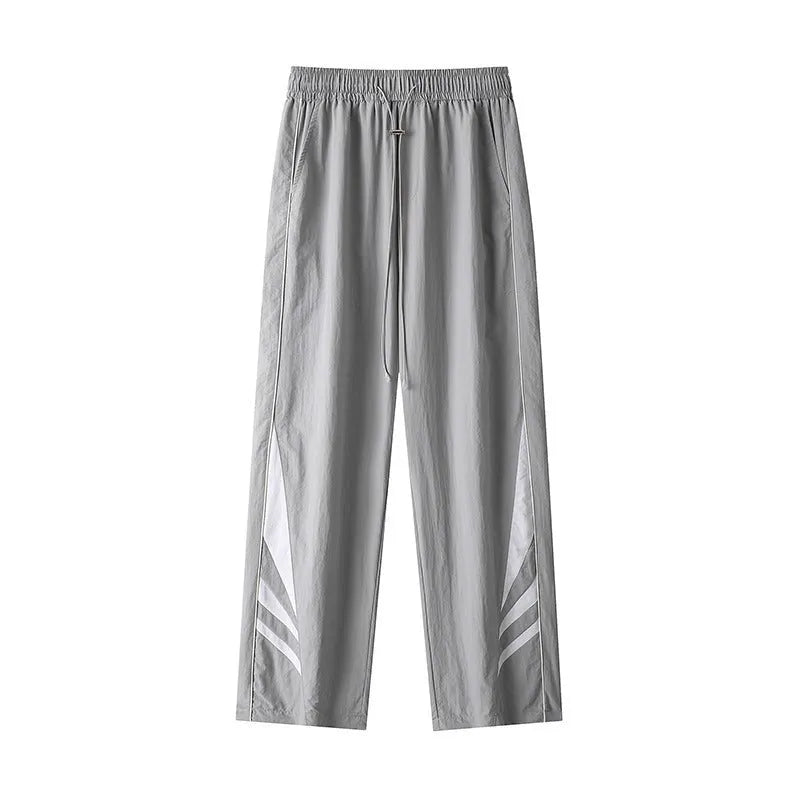 Men's straight-leg grey cotton blend sports trousers with an elasticated waistband laid flat.