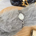 Ladies steel strap watch with oval hollow chain, silver case, white face, casual style