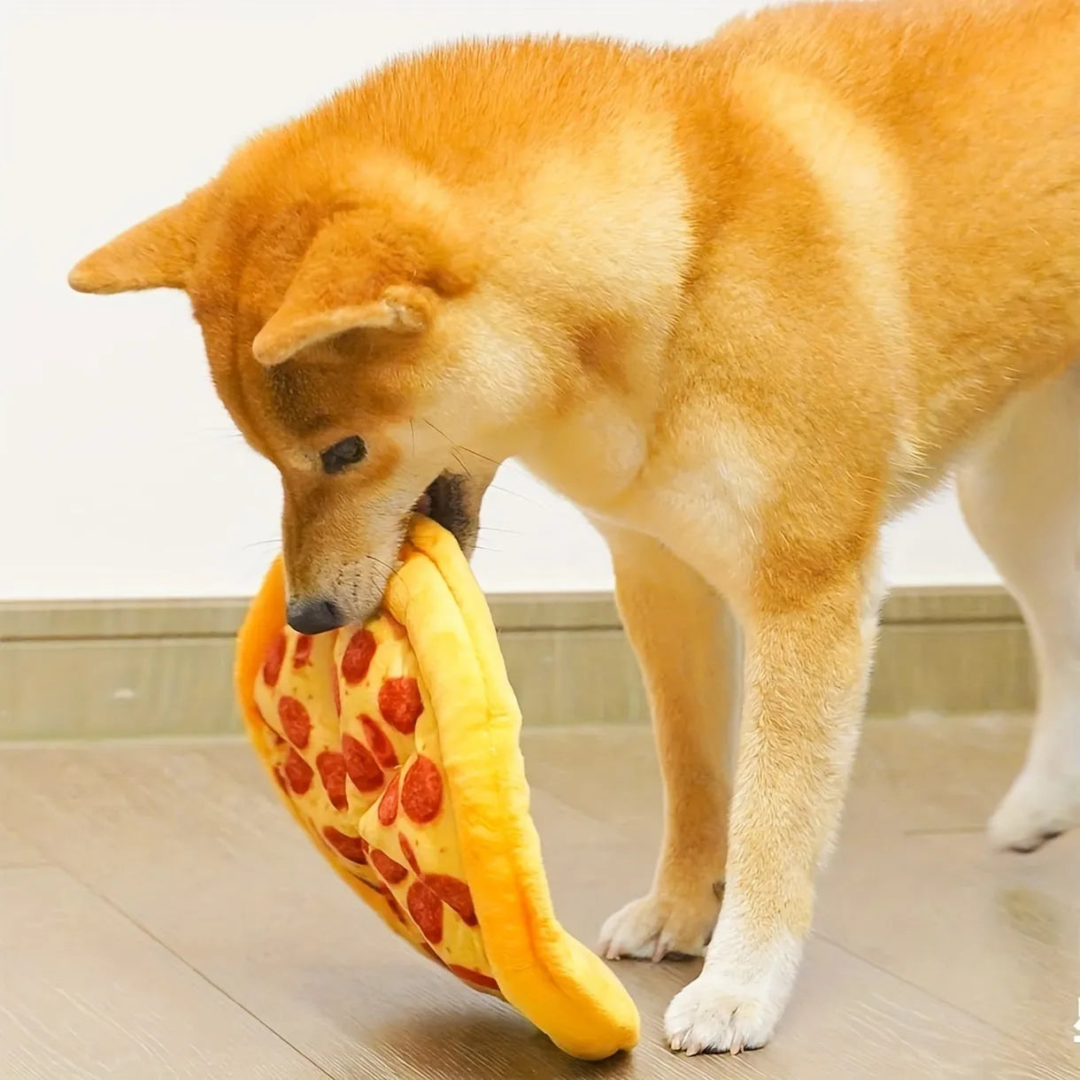Yellow pizza slice plush dog chew toy with textured grinding surface