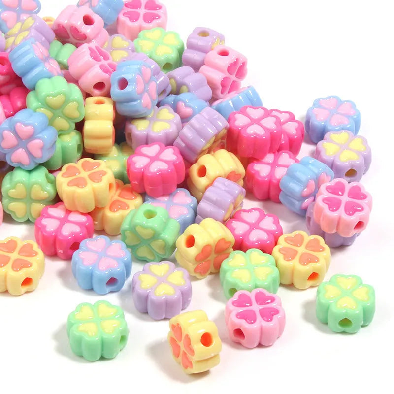 Assortment of 15mm frosted acrylic four-leaf clover beads in rose red, pink, yellow, green, blue, and purple.