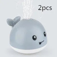 Electric whale-shaped bath spray toy with water-activated automatic spray, LED lights, and floating capability