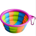Collapsible silicone dog bowl in camouflage pattern folded flat on green surface