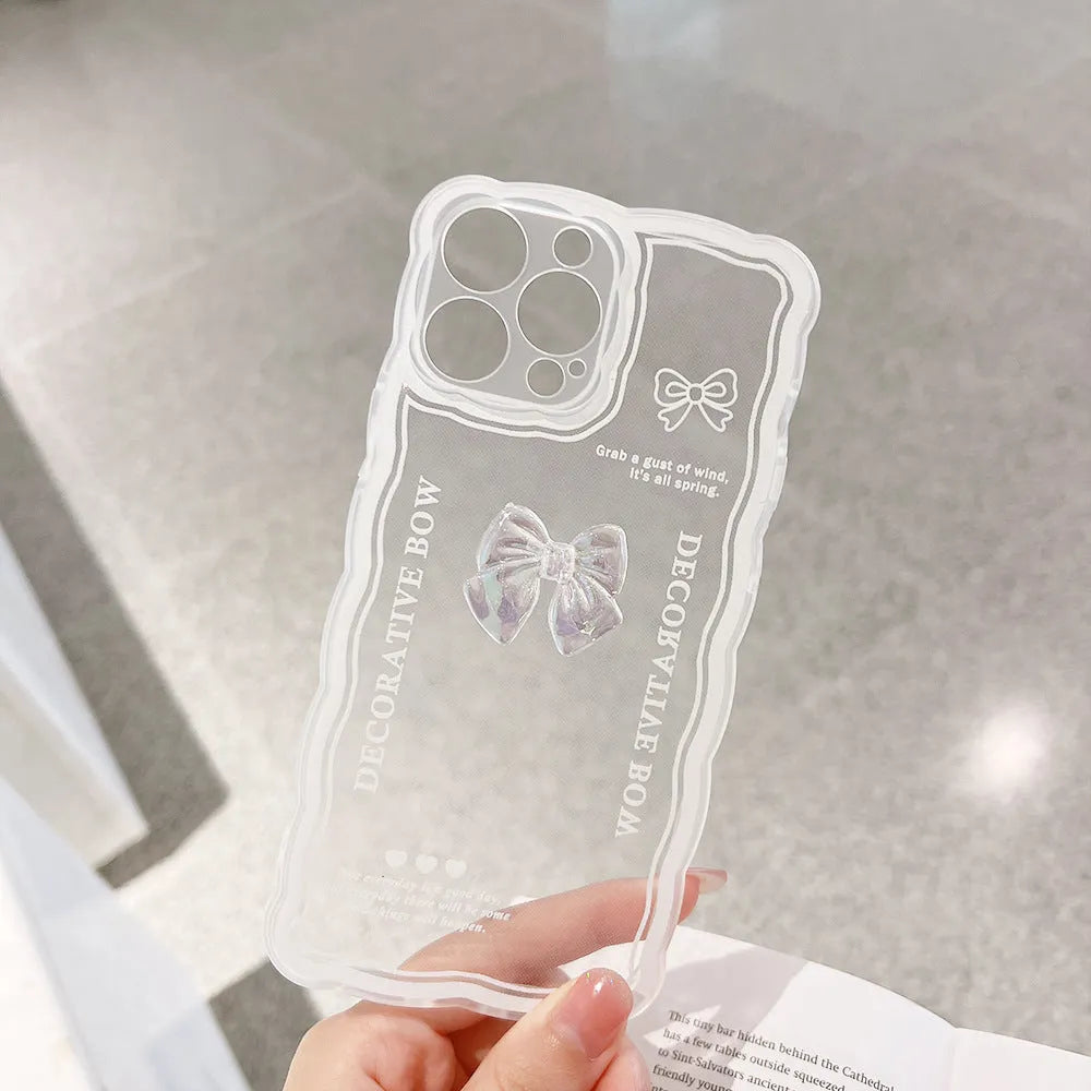 Clear iPhone case with a raised ice bow design, shown next to a white phone lanyard.