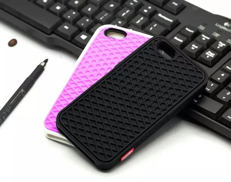 Waffle sole silicone phone case for iPhone 6s with checker pattern texture in black edge on brown background