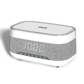 White multifunctional alarm clock with Bluetooth speaker and wireless charging pad showing night light illumination