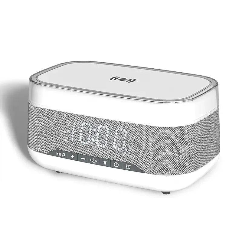 White multifunctional alarm clock with Bluetooth speaker and wireless charging pad showing night light illumination