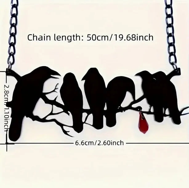 Black Gothic crow necklace with electroplated finish and cross chain on dark background