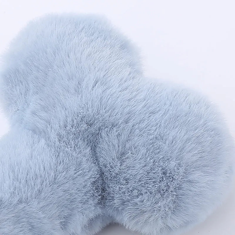 Blue love bone shaped plush dog toy with a squeaker, on a neutral background