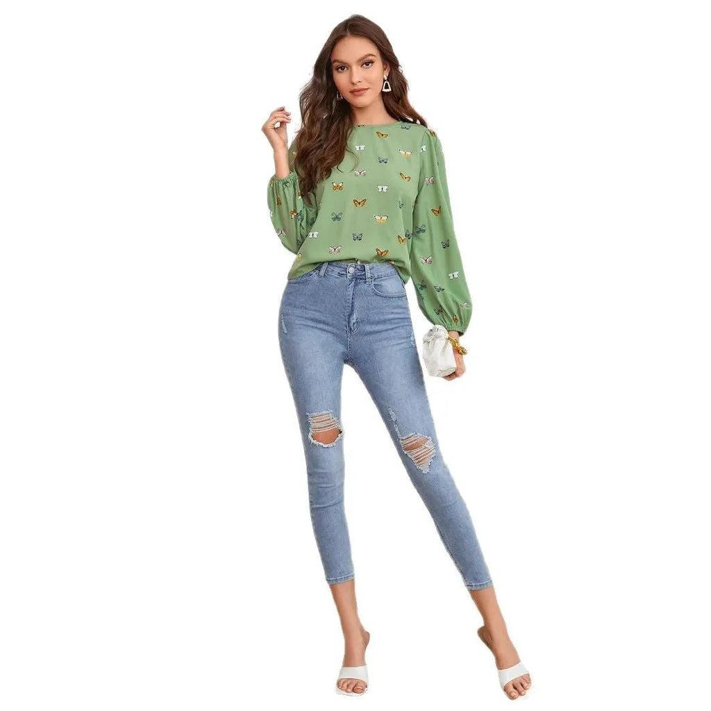 Women's green long-sleeved loose shirt with butterfly print pattern.